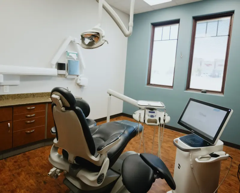 A bright Hilltop treatment room with a dental chair and windows