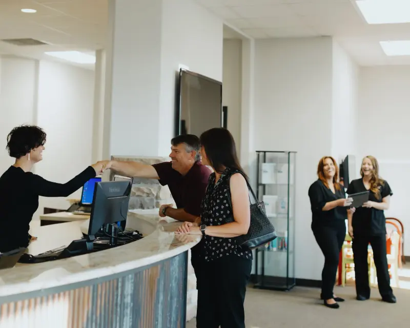 The Hilltop reception desk with team members helping patients